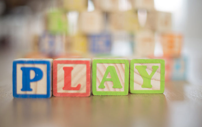 Blocks spelling the word "play"