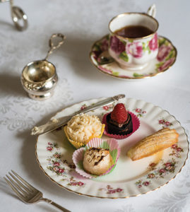 Scone and other sweets on a plate.