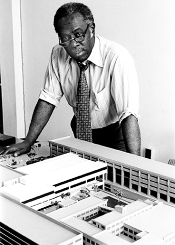Madison looks over the model for CSU's College of Sciences and Health Professions, which he designed in the early 1980s.