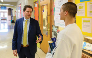David Glasner speaking with a student at Shaker High