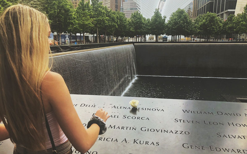 Leiken places a flower at the 9/11 Memorial in New York City