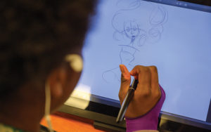 Shaker High artist drawing on a tablet