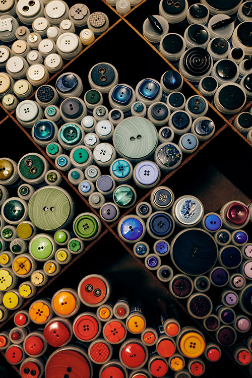 Colorful array of buttons on shelf