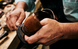 Carlos Gomez repairing a shoe