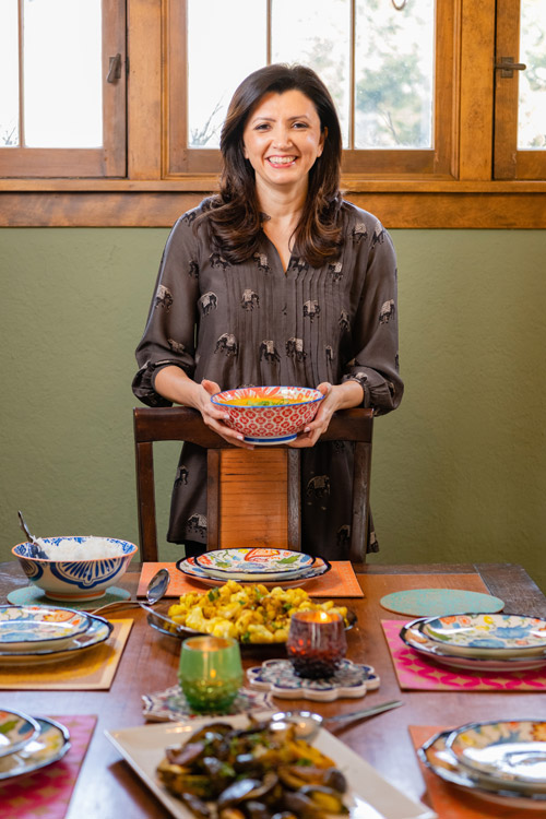 Sahar Rizvi at the dining table with prepared foods