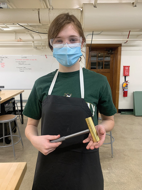 Senior Katy Christian shows off the hammer she made in the Machining and Manufacturing class. She couldn’t wait to put her classroom experience to work in a real-life setting at Shaker Numeric.