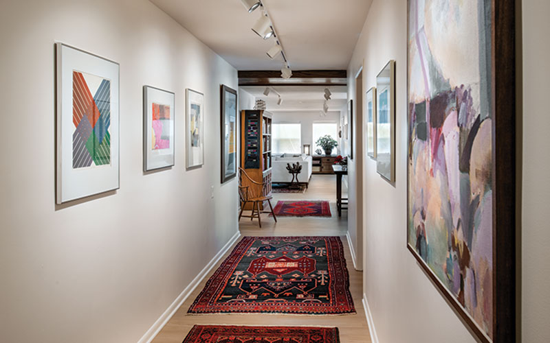 The art collection turns a transitional hallway space into a place to linger and look.