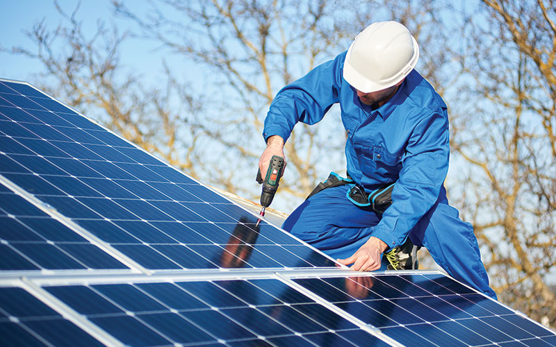 Man installing solar panels