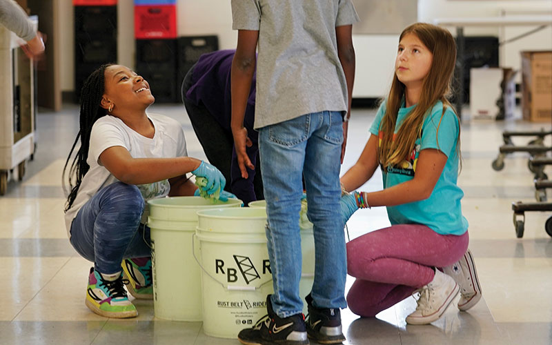 Students at Onaway School with compost buckets