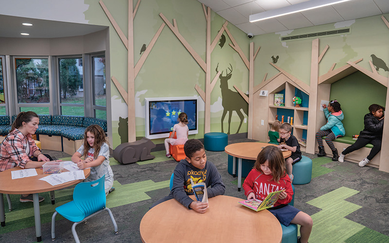 Children play, read, and color in the newly renovated children’s room at the Bertram Woods Branch.