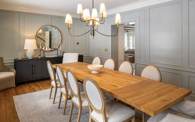 The dining room showcases restored architectural details, including crown molding, wall detail, and pocket doors.