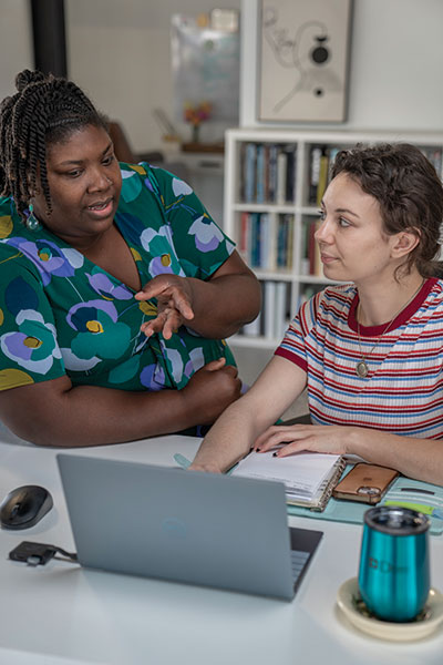 Desired Designs Owner Jakecia Durham works with Madeline Moriarty, the company's office manager.