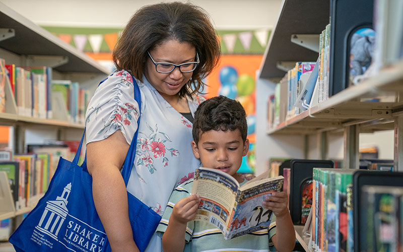Yvonne and Henry Smith browse the shelves in the children’s area at Shaker Main Library.