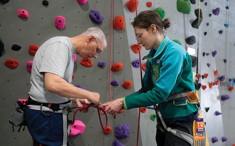 Kate Bliven. right, an occupational therapist, offers support to Mike Conner.
