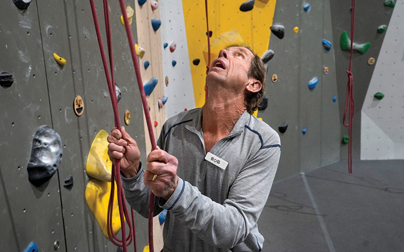 Shaker resident Bob Tucker checks the ropes before climbing at Shaker Rocks