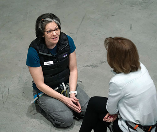 Gwen Hobbs, a volunteer with InMotion, talks with a group member