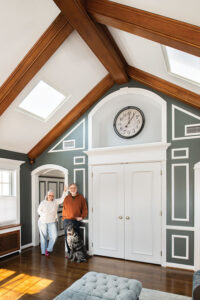 Pat and John Chapman with their dog, Dazzle, in doorway of their second floor sitting room.