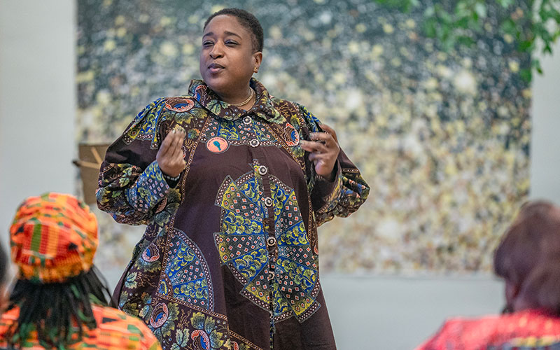 Dana Perkins leads an audience participation portion of her poem, “Small Eyes.”