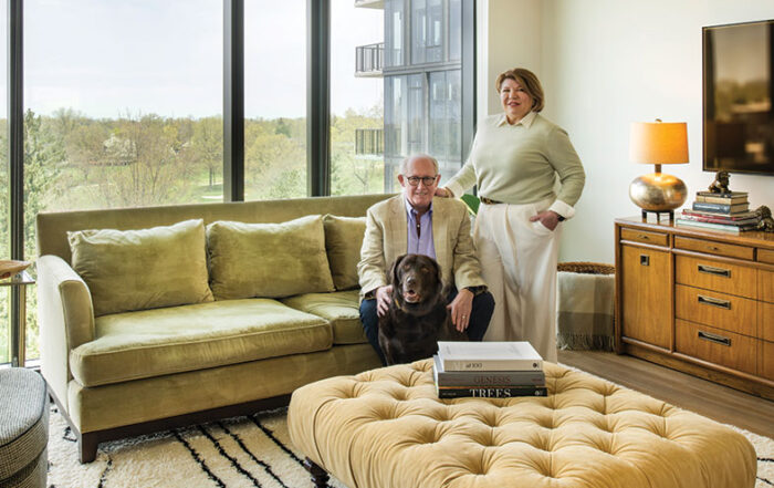 Alecia and Arik Anderson and their dog Betty in their living room that overlooks the Shaker Heights Country Club golf course.