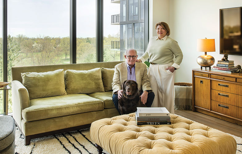 Alecia and Arik Anderson and their dog Betty in their living room that overlooks the Shaker Heights Country Club golf course.