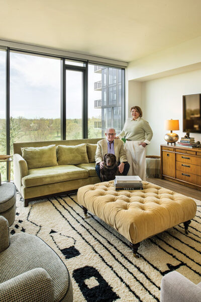 Alecia and Arik Anderson and their dog Betty in their living room that overlooks the Shaker Heights Country Club golf course.