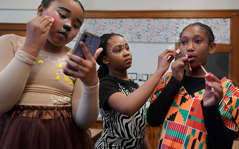 Students putting on makeup for their Lion King performance at Lomond School