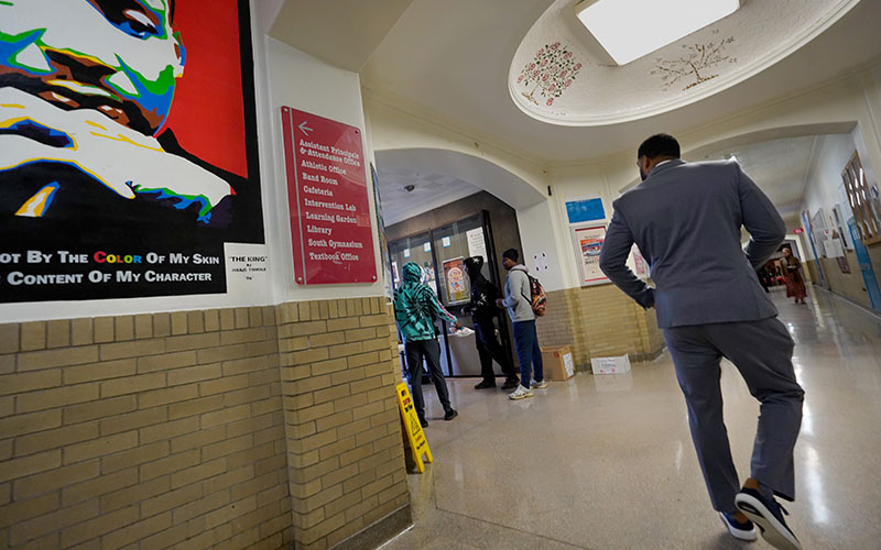Isaiah Wyatt walking in hallway at Shaker High