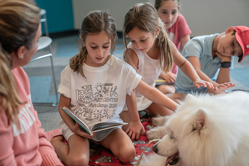 Children reading to a dog at Shaker Library