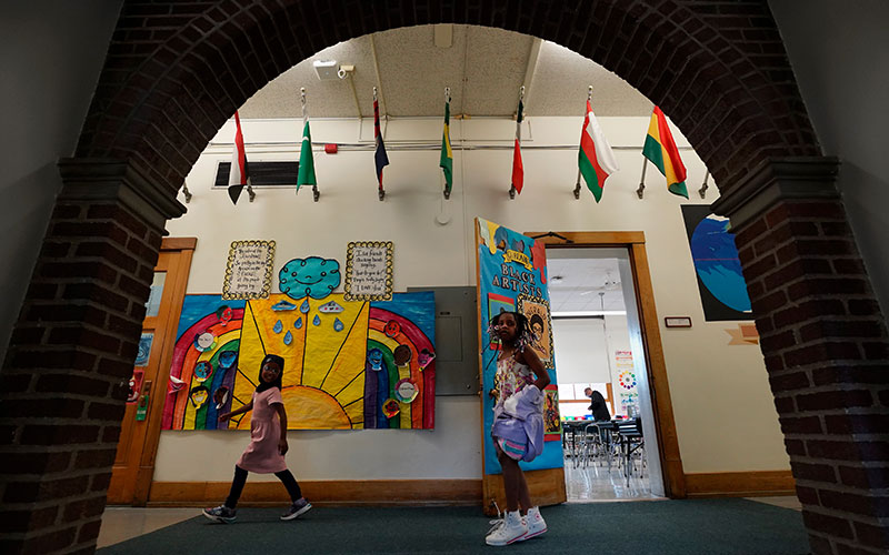 Students in hallway decorated with international flags and art