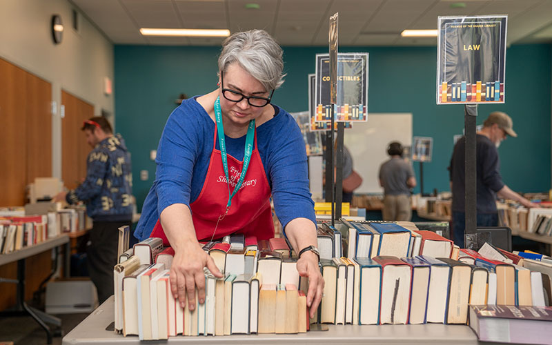 Volunteer setting up for library sale